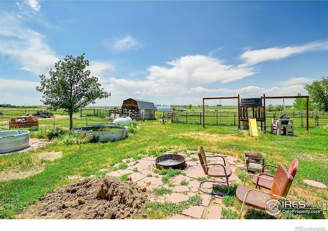18247 County Road 22, Fort Lupton, CO 80621 - view of yard featuring an outdoor fire pit and an outdoor structure