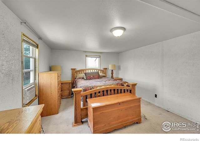 18247 County Road 22, Fort Lupton, CO 80621 - bedroom featuring light carpet, multiple windows, a textured wall, and cooling unit