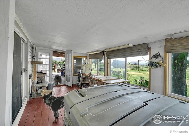 18247 County Road 22, Fort Lupton, CO 80621 - sunroom / solarium with a textured ceiling, hardwood / wood-style flooring, and healthy amount of natural light