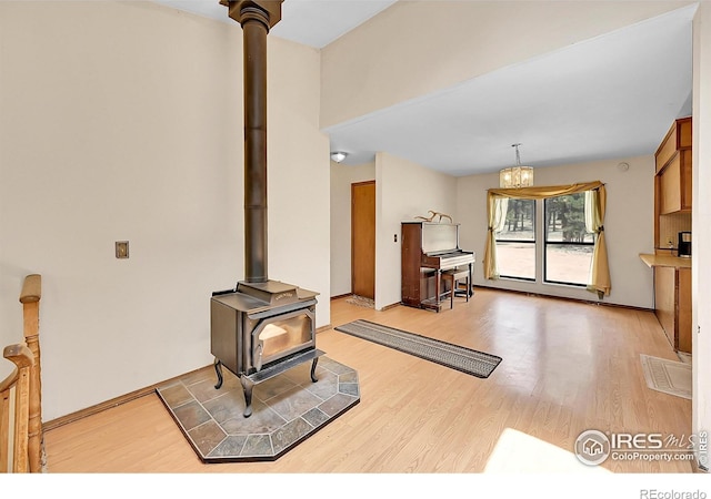 56 Bounty Hunter Ln, Bailey, CO 80421 - living room with a wood stove and light wood-style floors