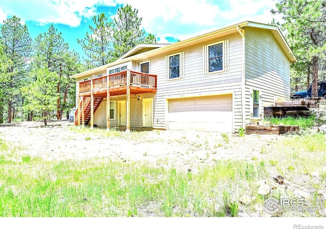 56 Bounty Hunter Ln, Bailey, CO 80421 - view of front of property with stairway, a garage, and a wooden deck