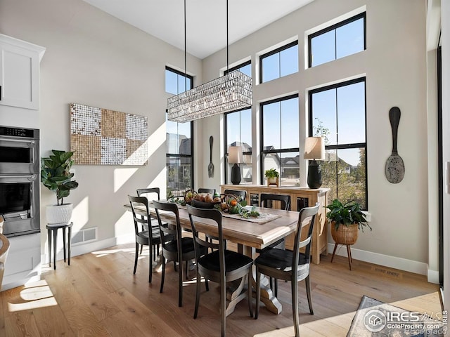 1255 Eliza Ave, Berthoud, CO 80513 - dining space with light wood-style floors and a high ceiling