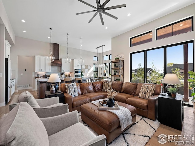1255 Eliza Ave, Berthoud, CO 80513 - living area featuring a ceiling fan, light wood finished floors, recessed lighting, and a towering ceiling