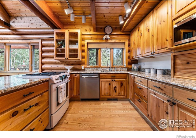 178 Hazelwood Dr, Nederland, CO 80466 - kitchen featuring appliances with stainless steel finishes, track lighting, log walls, a wooden ceiling with exposed beams, and light wood-style floors