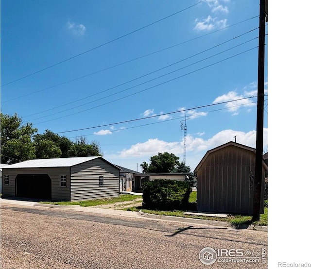151 W 1st St N, Cheyenne Wells, CO 80810 - view of property exterior with an outbuilding and a garage
