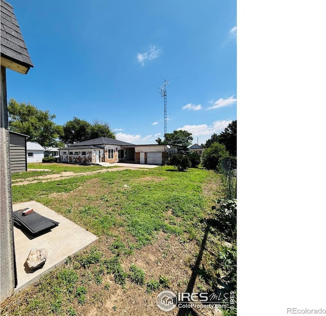 151 W 1st St N, Cheyenne Wells, CO 80810 - view of grassy yard with a patio area