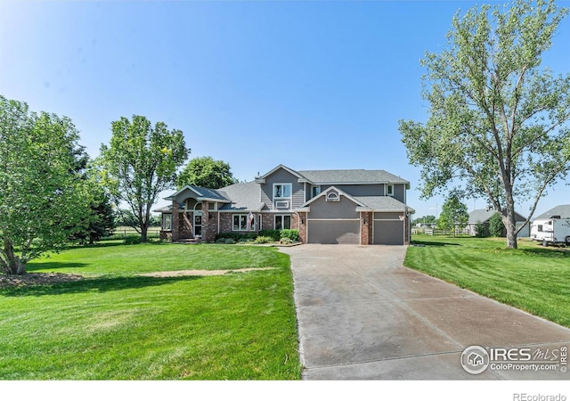 4615 Kitchell Way, Fort Collins, CO 80524 - view of front of house with concrete driveway, a front yard, an attached garage, and brick siding