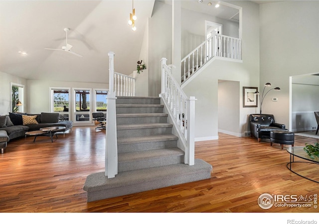 4615 Kitchell Way, Fort Collins, CO 80524 - staircase with high vaulted ceiling, wood finished floors, and ceiling fan