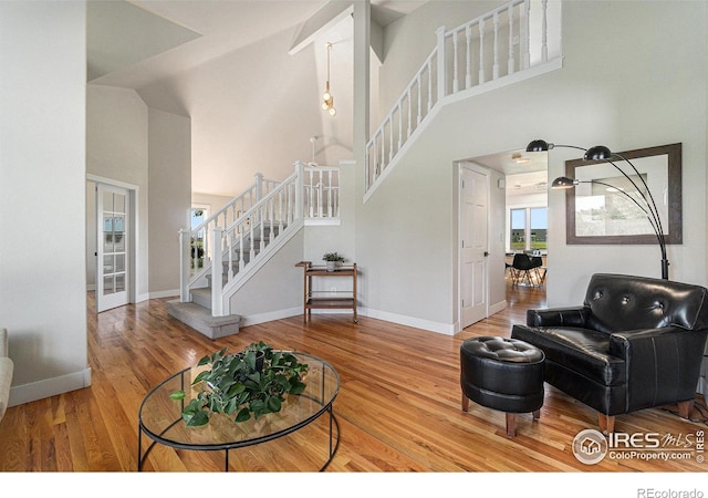 4615 Kitchell Way, Fort Collins, CO 80524 - living area featuring stairs, a towering ceiling, and wood finished floors