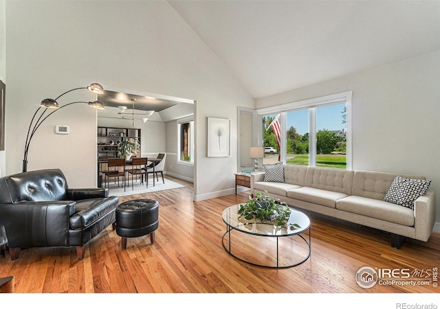 4615 Kitchell Way, Fort Collins, CO 80524 - living area with high vaulted ceiling, light wood-type flooring, and a chandelier