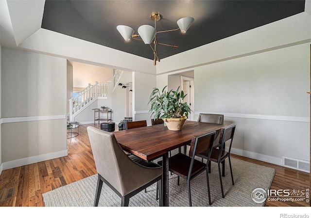 4615 Kitchell Way, Fort Collins, CO 80524 - dining space featuring a chandelier, stairway, and wood finished floors