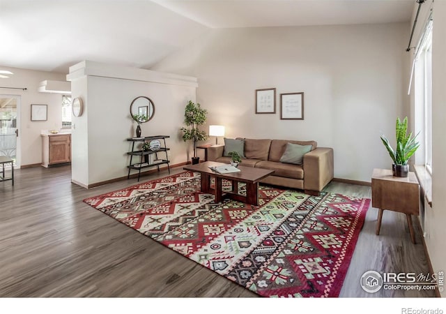 425 Walden Way, Fort Collins, CO 80526 - living area with healthy amount of natural light, wood finished floors, and vaulted ceiling