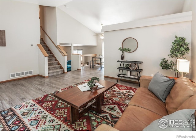 425 Walden Way, Fort Collins, CO 80526 - living room with wood finished floors, high vaulted ceiling, and stairs