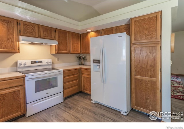 425 Walden Way, Fort Collins, CO 80526 - kitchen featuring white appliances, under cabinet range hood, wood finished floors, light countertops, and brown cabinets
