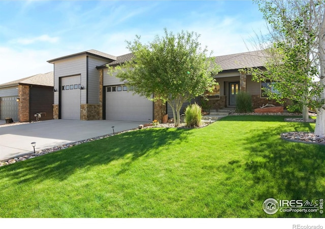 333 Braveheart Ln, Johnstown, CO 80534 - view of front facade with a garage, stone siding, driveway, a front yard, and roof with shingles