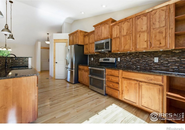 333 Braveheart Ln, Johnstown, CO 80534 - kitchen with appliances with stainless steel finishes, open shelves, lofted ceiling, light wood-style floors, and decorative backsplash