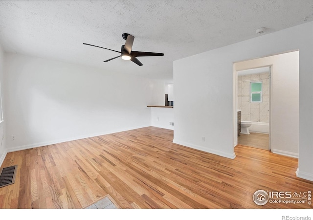 6755 W 33rd Ave, Wheat Ridge, CO 80033 - unfurnished living room with light wood-style floors, a textured ceiling, and a ceiling fan