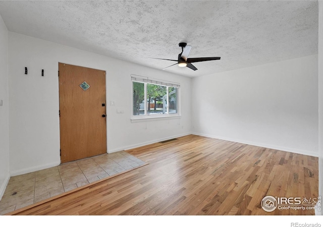 6755 W 33rd Ave, Wheat Ridge, CO 80033 - entrance foyer featuring ceiling fan, wood finished floors, and a textured ceiling