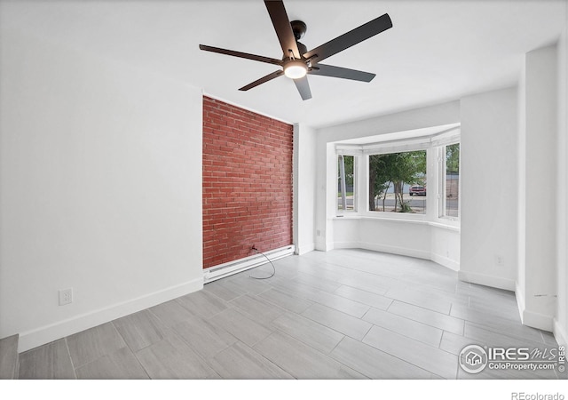 6755 W 33rd Ave, Wheat Ridge, CO 80033 - empty room featuring ceiling fan and brick wall