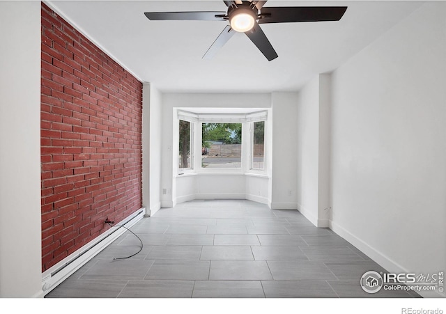 6755 W 33rd Ave, Wheat Ridge, CO 80033 - unfurnished room with brick wall, ceiling fan, baseboard heating, and tile patterned floors
