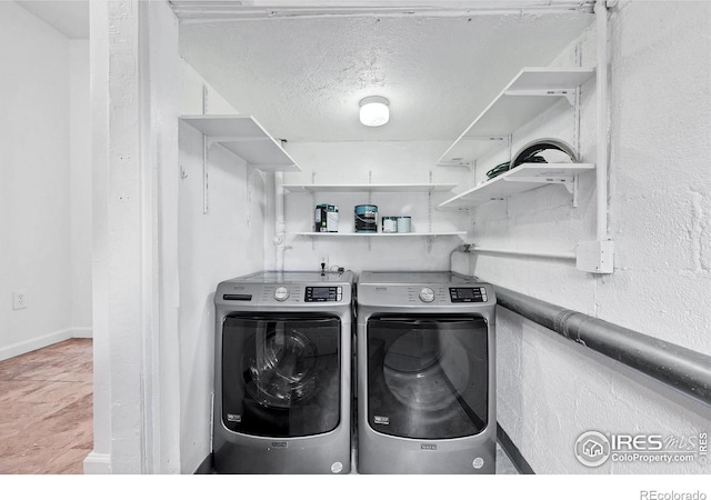 6755 W 33rd Ave, Wheat Ridge, CO 80033 - washroom featuring washer and clothes dryer and a textured ceiling