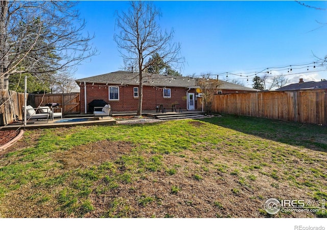 6755 W 33rd Ave, Wheat Ridge, CO 80033 - back of house with a patio, a fenced backyard, and brick siding