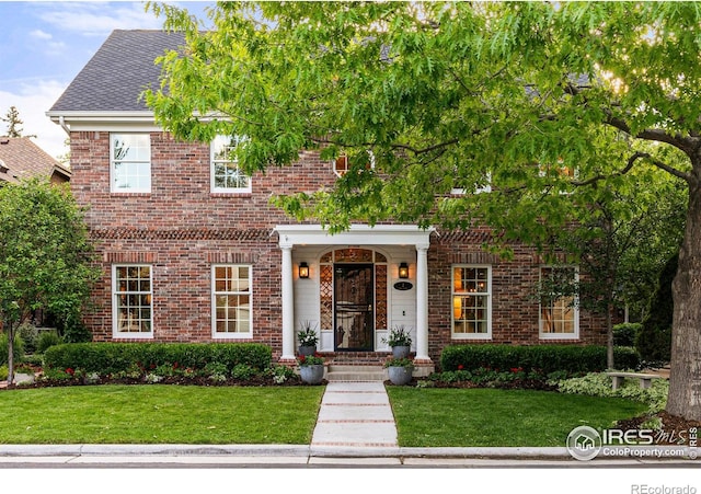 3000 E Cedar Ave Unit 2, Denver, CO 80209 - view of front of home with brick siding, a front lawn, and a shingled roof