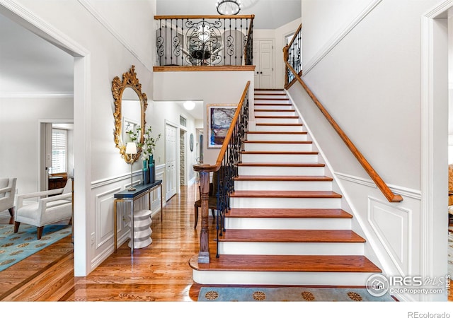 3000 E Cedar Ave Unit 2, Denver, CO 80209 - staircase featuring wood finished floors and ornamental molding