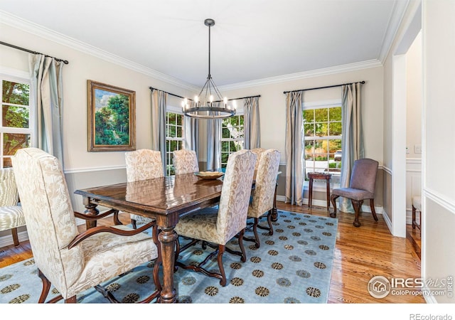 3000 E Cedar Ave Unit 2, Denver, CO 80209 - dining space featuring a chandelier, crown molding, plenty of natural light, and light wood-type flooring