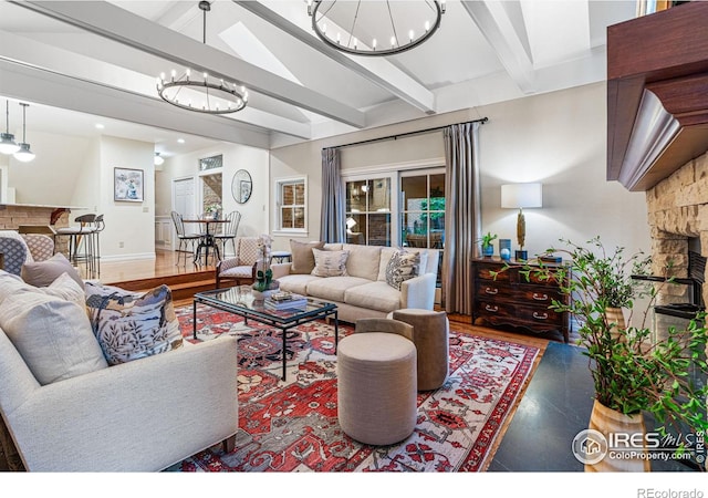 3000 E Cedar Ave Unit 2, Denver, CO 80209 - living area featuring a chandelier, wood finished floors, and a stone fireplace