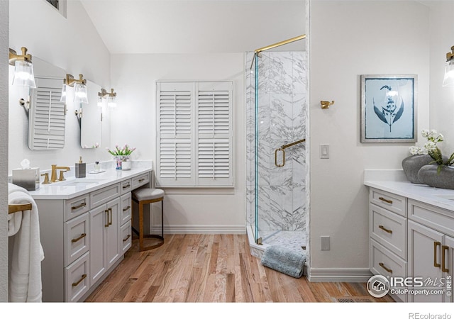 3000 E Cedar Ave Unit 2, Denver, CO 80209 - full bath featuring vanity, a marble finish shower, and wood finished floors