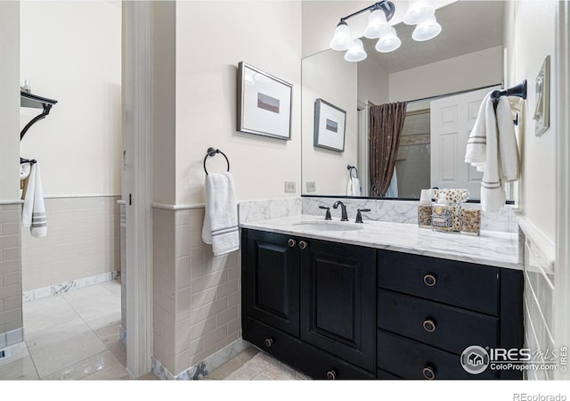3000 E Cedar Ave Unit 2, Denver, CO 80209 - full bathroom with vanity, a wainscoted wall, tile walls, and curtained shower