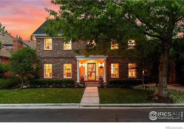 3000 E Cedar Ave Unit 2, Denver, CO 80209 - colonial home featuring brick siding and a yard