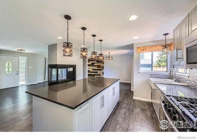5491 E 117th Ave, Thornton, CO 80233 - kitchen featuring stainless steel appliances, dark wood-style floors, a kitchen island, recessed lighting, and hanging light fixtures