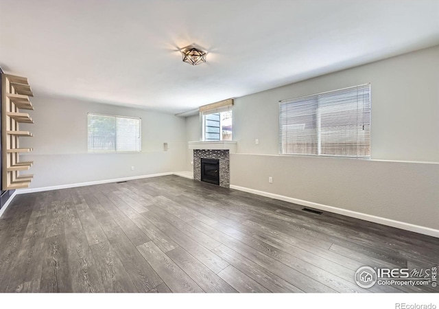 5491 E 117th Ave, Thornton, CO 80233 - unfurnished living room with a fireplace and wood finished floors