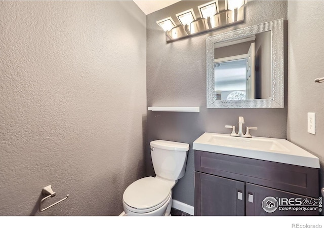 5491 E 117th Ave, Thornton, CO 80233 - half bathroom featuring a textured wall and vanity