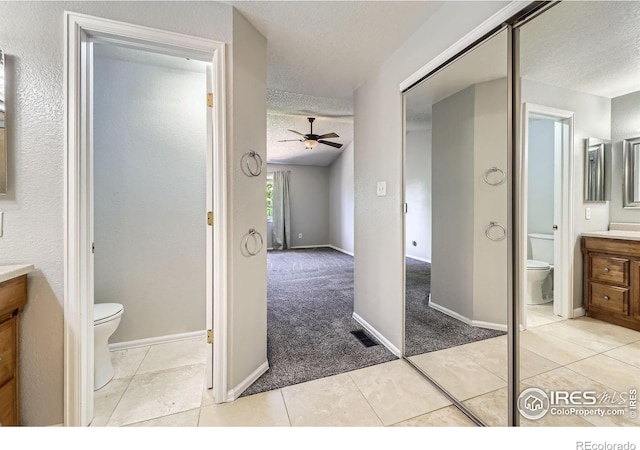 5491 E 117th Ave, Thornton, CO 80233 - bathroom featuring a textured ceiling, vanity, ceiling fan, and tile patterned flooring