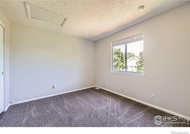 5491 E 117th Ave, Thornton, CO 80233 - carpeted spare room featuring a textured ceiling, a smoke detector, and attic access