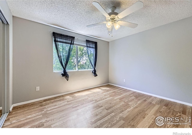 5491 E 117th Ave, Thornton, CO 80233 - spare room with wood finished floors, ceiling fan, and a textured ceiling