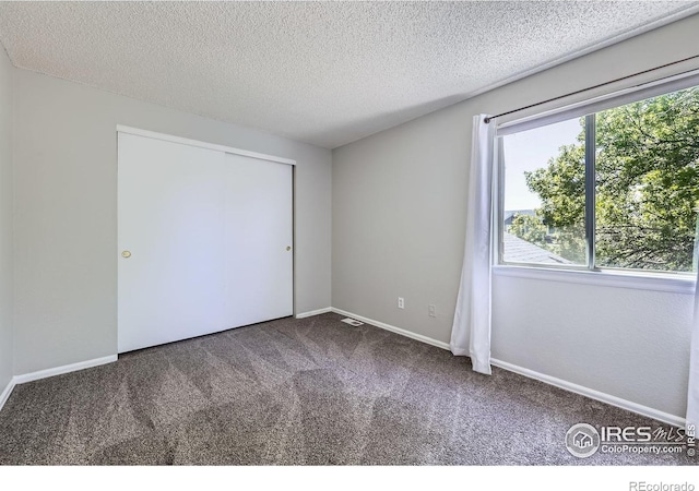 5491 E 117th Ave, Thornton, CO 80233 - unfurnished bedroom with carpet, a textured ceiling, and a closet