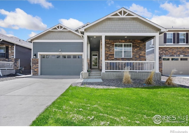 1781 Summer Bloom Dr, Windsor, CO 80550 - craftsman-style home featuring stone siding, a garage, concrete driveway, covered porch, and a front yard