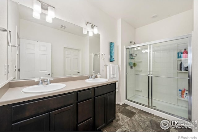 1781 Summer Bloom Dr, Windsor, CO 80550 - full bathroom featuring double vanity and a stall shower