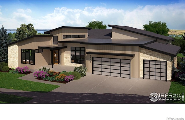 2669 Southwind Dr, Berthoud, CO 80513 - contemporary house with stone siding, an attached garage, and driveway