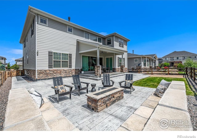 1389 Lyons Ln, Erie, CO 80516 - fenced backyard with an outdoor fire pit, a patio, ceiling fan, and a residential view