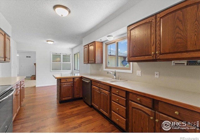 3400 Erving Ct, Berthoud, CO 80513 - kitchen with appliances with stainless steel finishes, light countertops, dark wood-style floors, a textured ceiling, and a peninsula