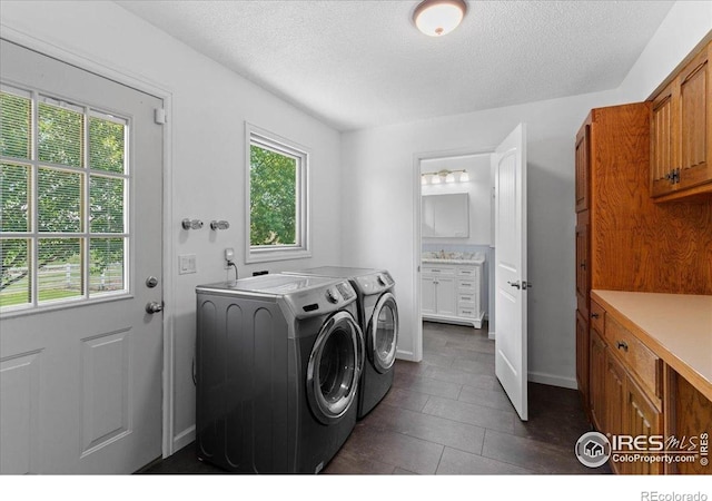3400 Erving Ct, Berthoud, CO 80513 - laundry room with washer and clothes dryer, a textured ceiling, and dark tile patterned flooring