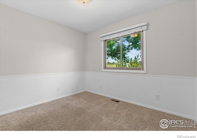3400 Erving Ct, Berthoud, CO 80513 - spare room with a wainscoted wall and carpet flooring