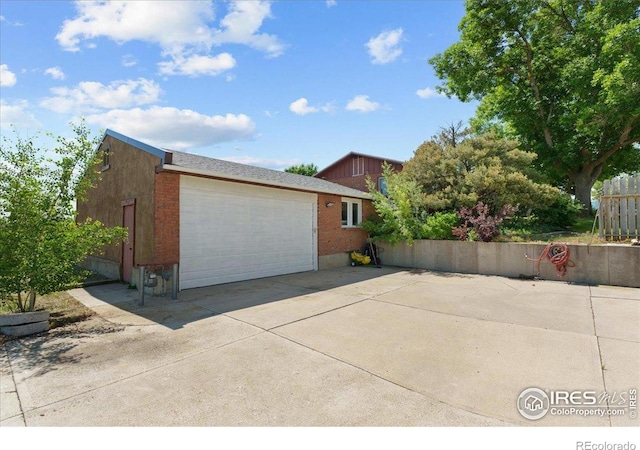 3400 Erving Ct, Berthoud, CO 80513 - view of side of home featuring an attached garage, driveway, and brick siding