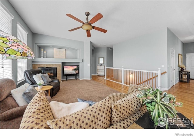 2707 Pochard Ct, Johnstown, CO 80534 - living room featuring ceiling fan, a glass covered fireplace, and wood finished floors