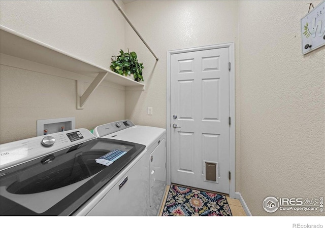 2707 Pochard Ct, Johnstown, CO 80534 - washroom featuring washer and dryer and a textured wall